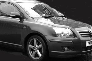 Monochrome image of STS Taxis Sawbridgeworth Toyota taxi